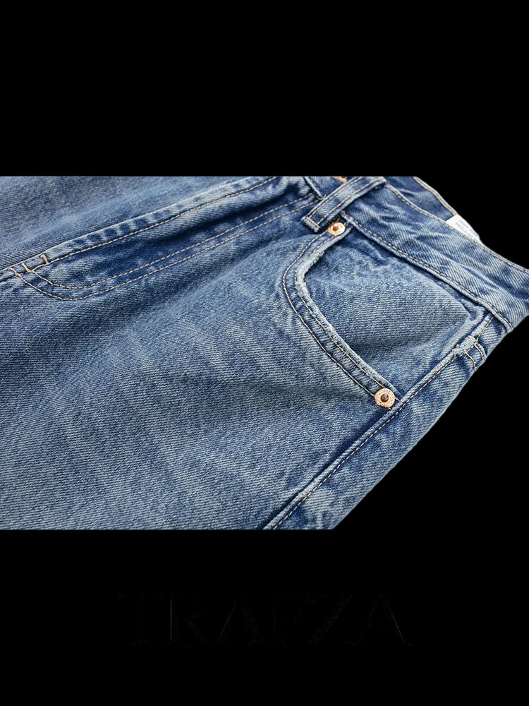 Close-up of blue jeans with 'TRAFZA' branding on a white background
