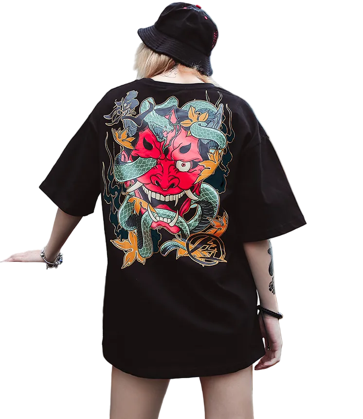 Person wearing a black t-shirt with a colorful graphic design outdoors.