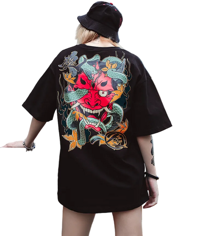 Person wearing a black t-shirt with a colorful graphic design outdoors.