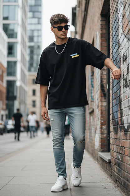 Black t-shirt with a logo on the chest against a white background