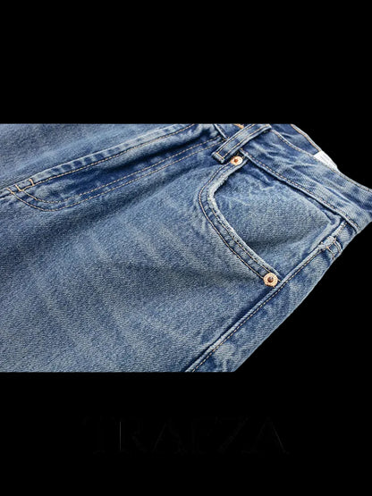 Close-up of blue jeans with 'TRAFZA' branding on a white background