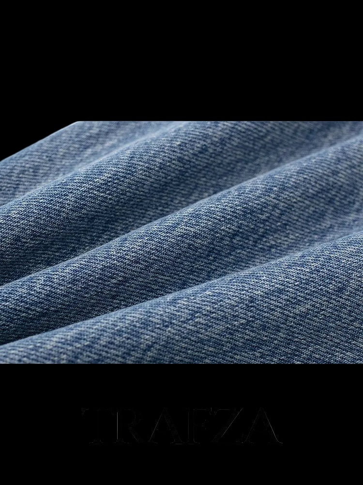 Close-up of blue denim fabric with 'TRAFZA' branding at the bottom.