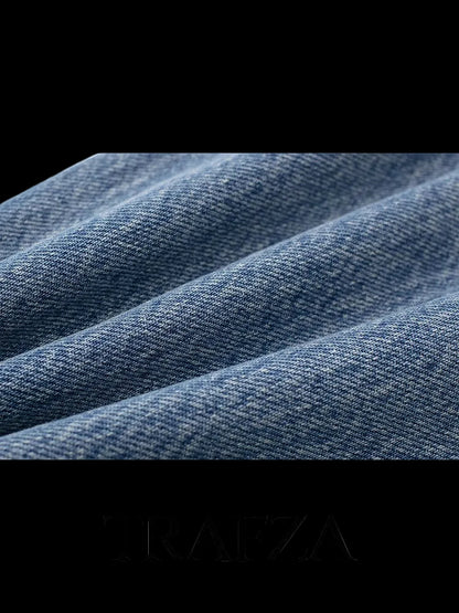 Close-up of blue denim fabric with 'TRAFZA' branding at the bottom.