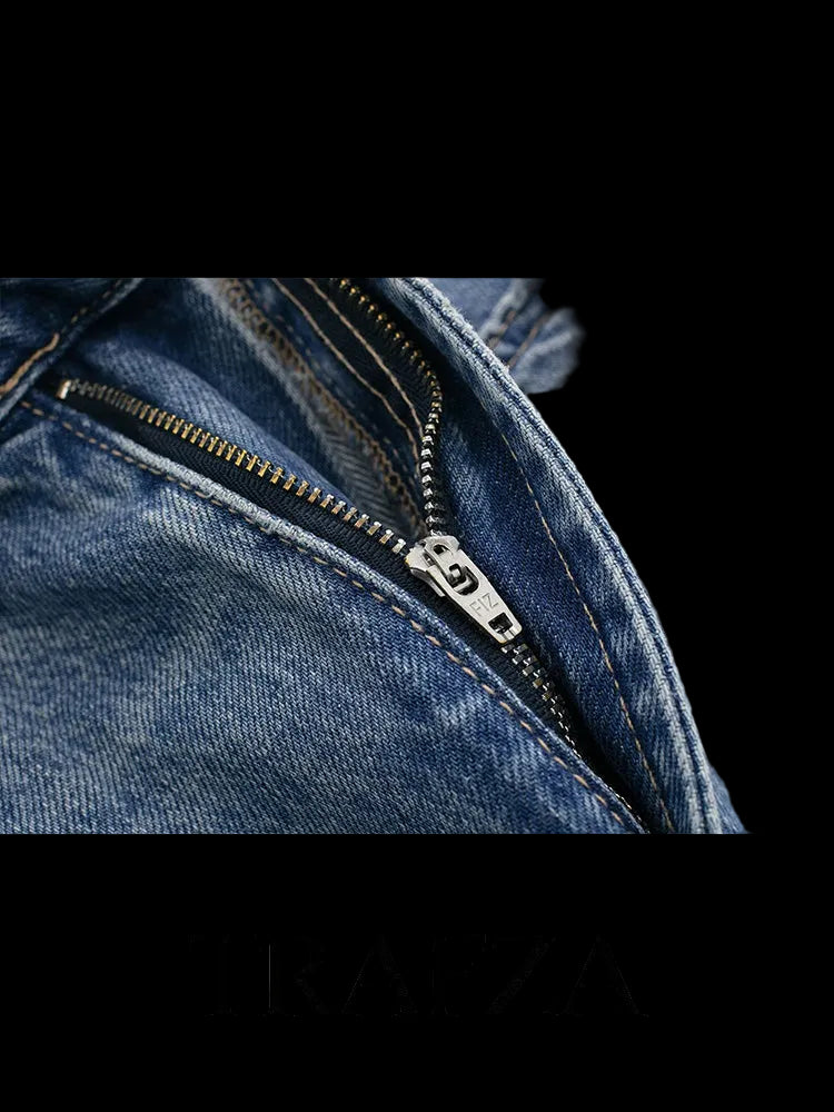 Close-up of a blue denim jacket with a zipper, featuring the brand 'Trafza'.