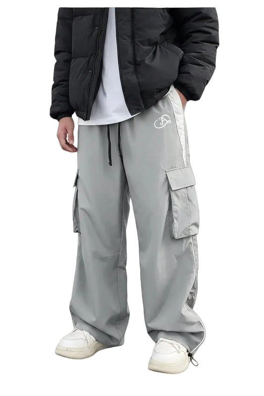 Person wearing gray track pants with a brand logo on a white background